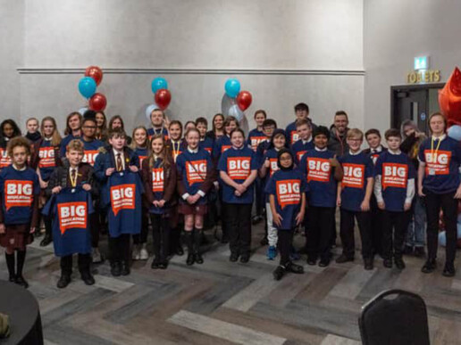 Group of pupils with big education conversation tops
