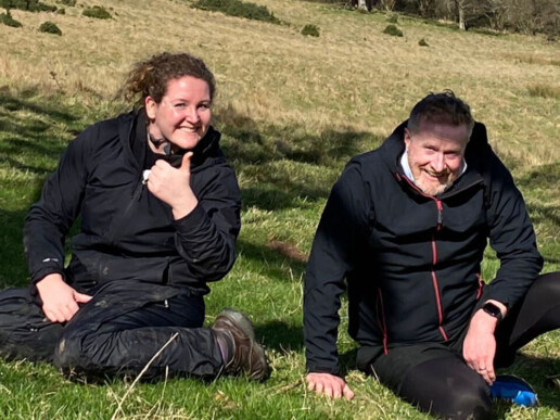 James and colleague sat on a hillside