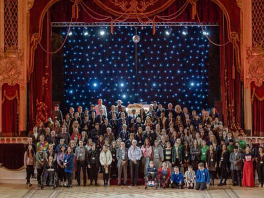 Large group of people on a theatre stage